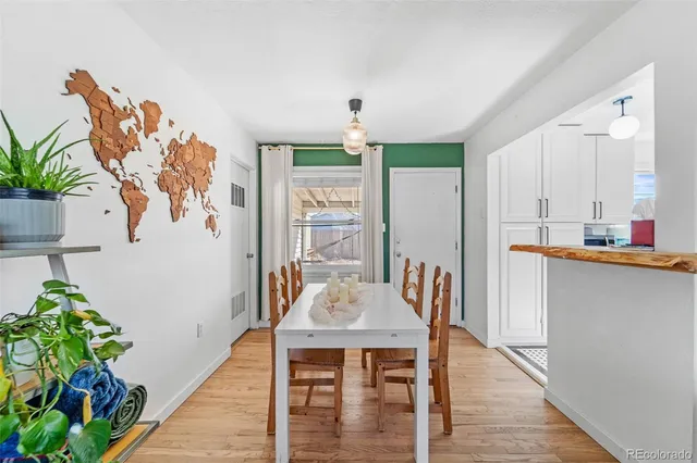 a view of a dining room with furniture window and wooden floor