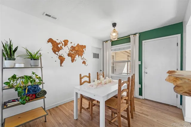 a view of a dining room with furniture window and wooden floor