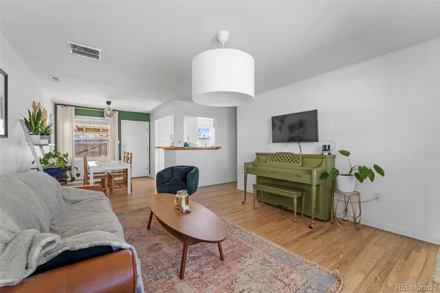 a living room with furniture and a lamp
