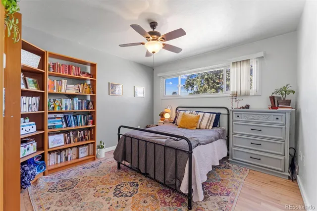 a bedroom with a bed and a book shelf