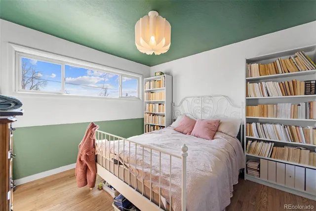 a bedroom with a bed and a book shelf