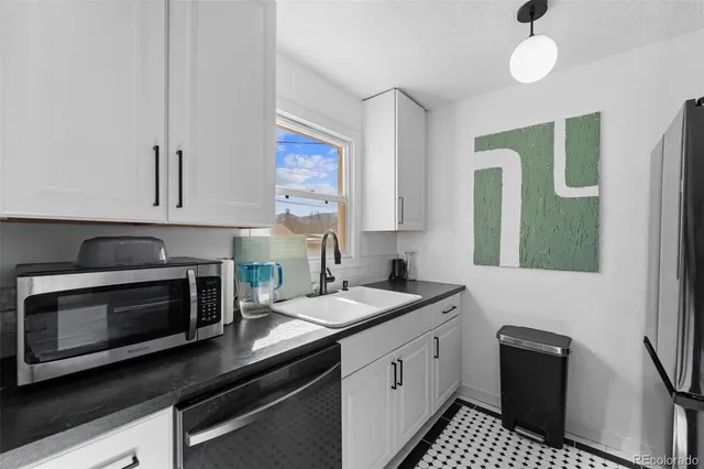 a kitchen with a sink stove and microwave