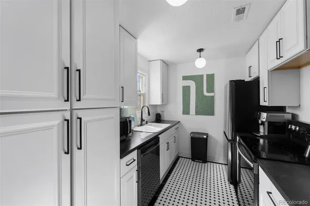 a kitchen with a sink stove and refrigerator