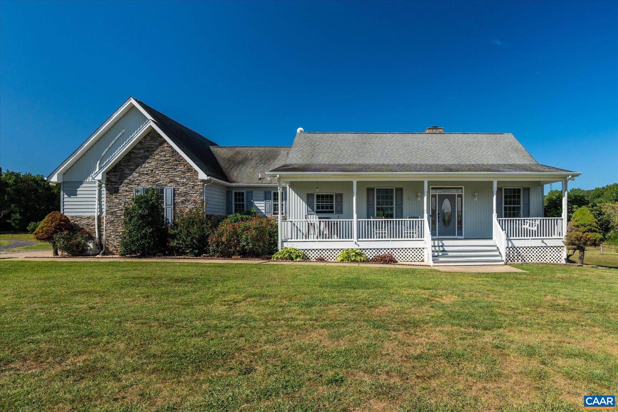 a front view of a house with a garden and porch