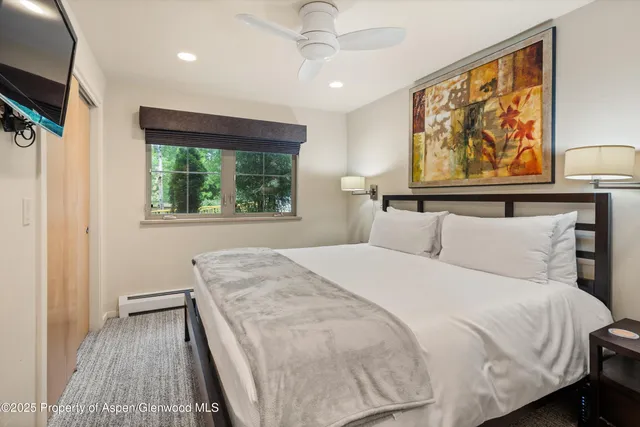 a bedroom with a large bed and a window