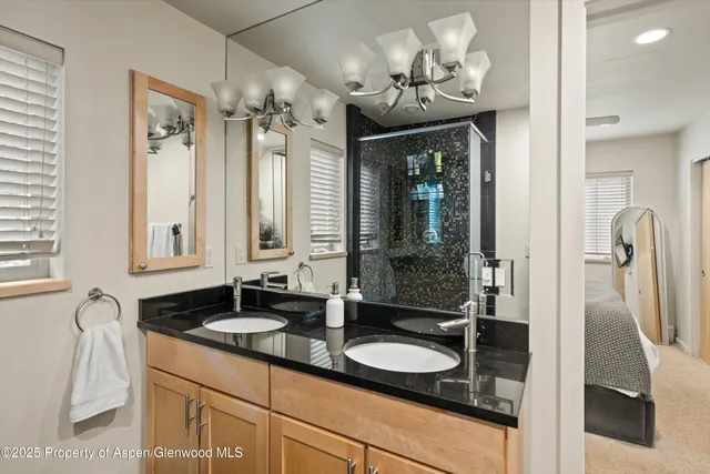 a bathroom with a double vanity sink and a mirror