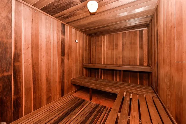 a view of front door with wooden floor and a shower