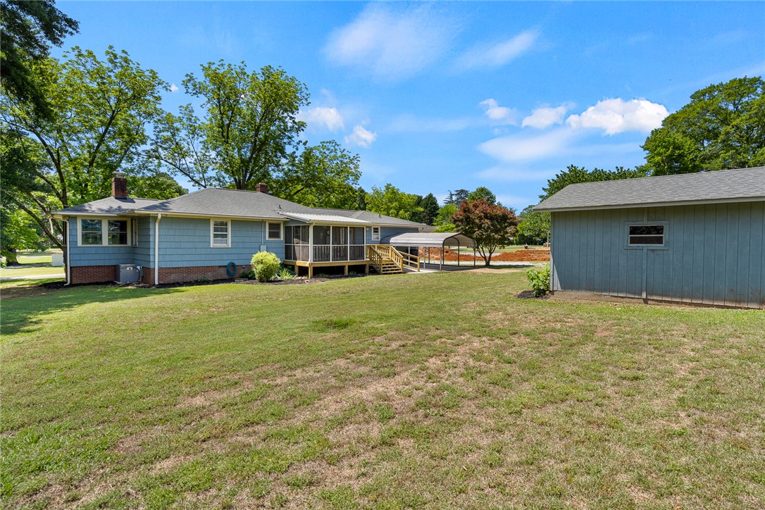 1509 869 Anderson, SC 29621 - Photo 39 of 45 A generous backyard offers a screened porch and a detached storage shed, perfect for outdoor living and utility.