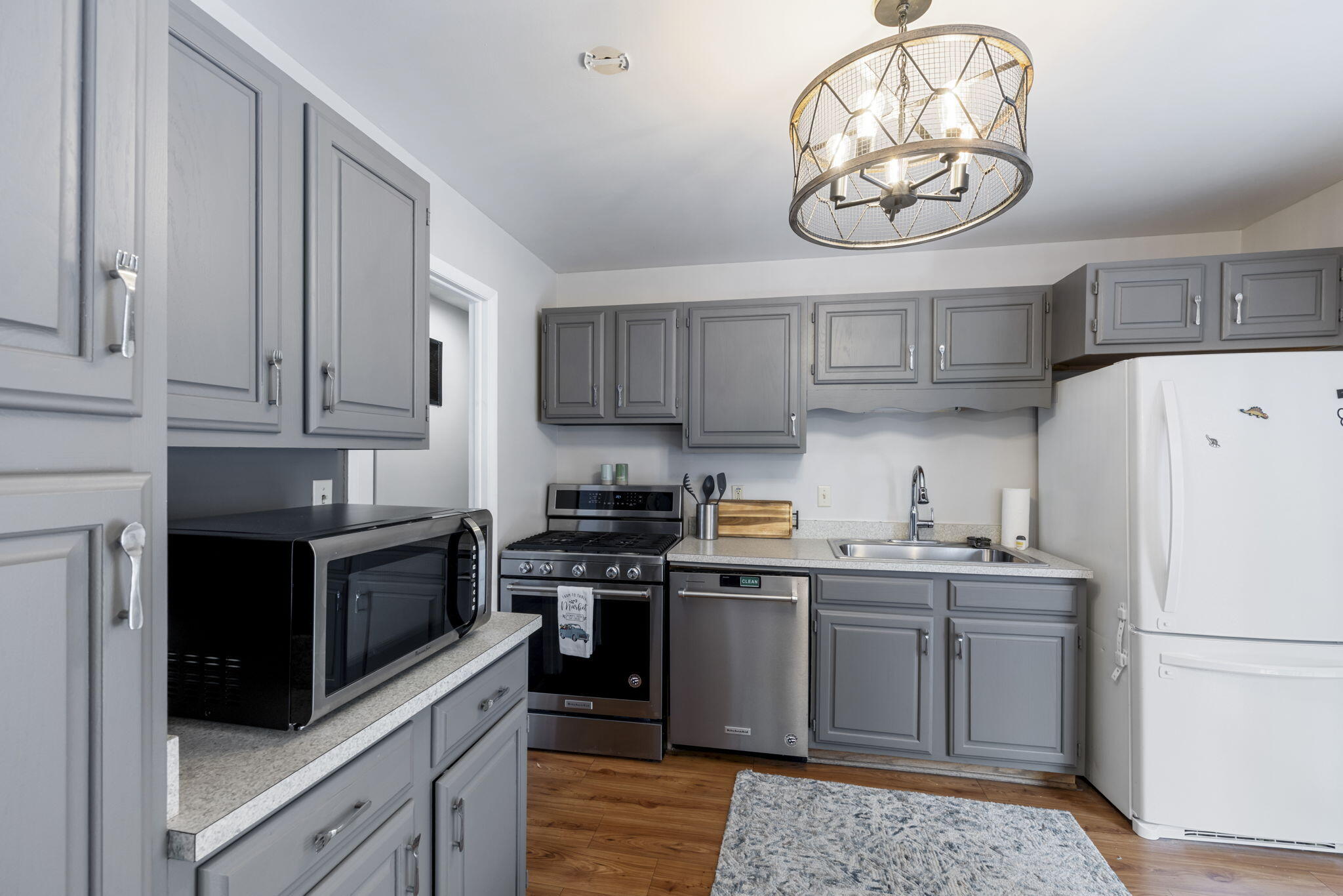1807 West Porter Avenue Chesterton, IN 46304 - Photo 4 of 23 a kitchen with a sink a refrigerator and cabinets