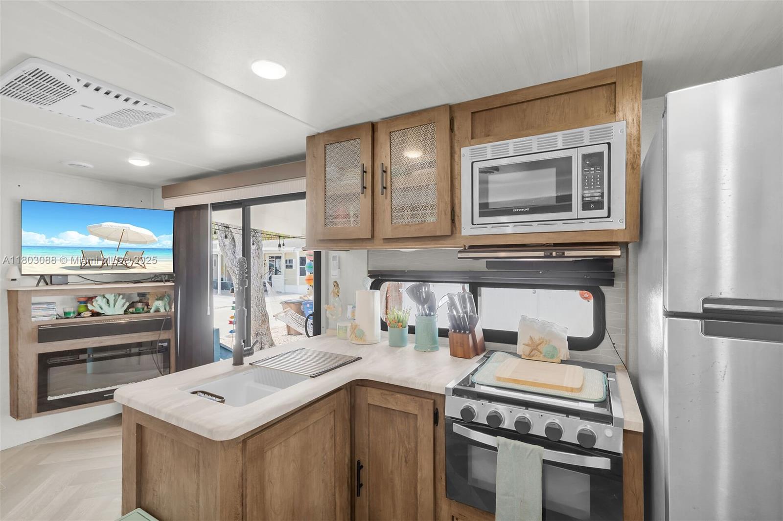 325 Calusa Street Key Largo, FL 33037 - Photo 13 of 34 a kitchen with stainless steel appliances granite countertop a stove a sink and a refrigerator