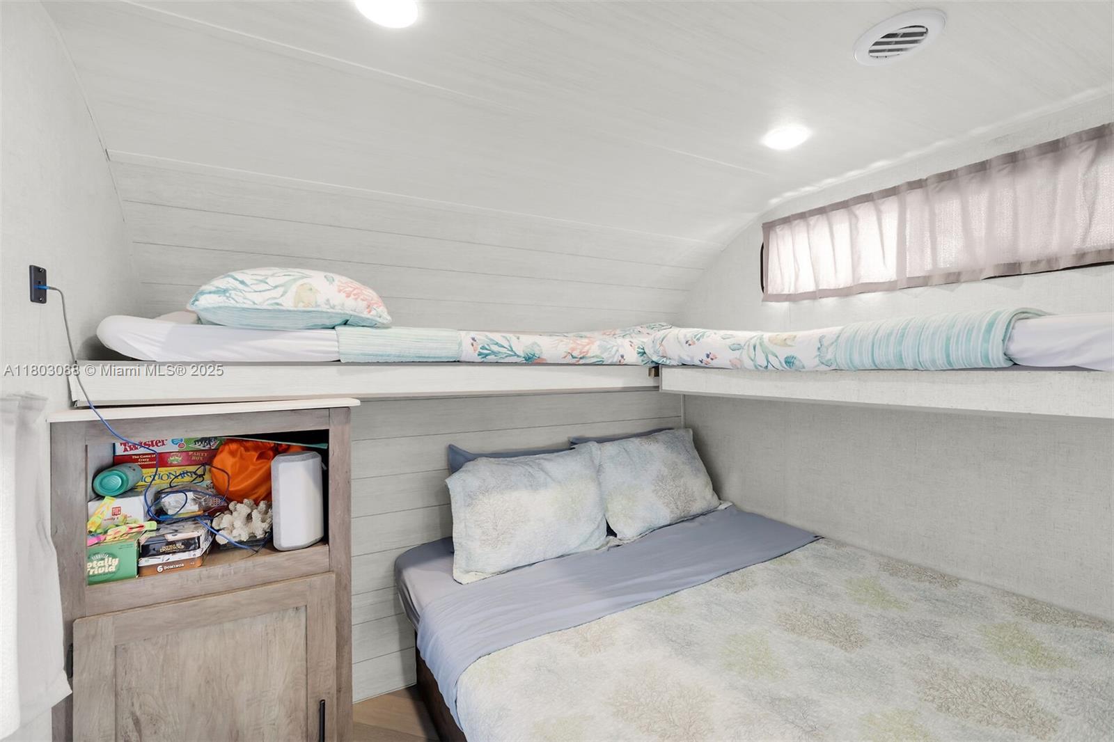 325 Calusa Street Key Largo, FL 33037 - Photo 17 of 34 a bedroom with a bed and ceiling fan