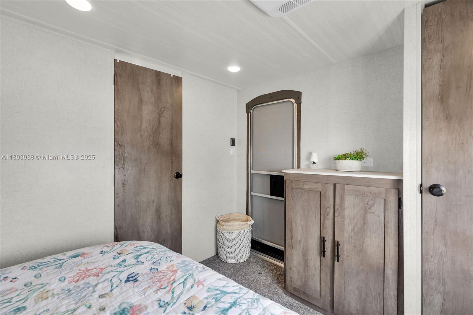 325 Calusa Street Key Largo, FL 33037 - Photo 18 of 34 a bedroom with a bed and a potted plant