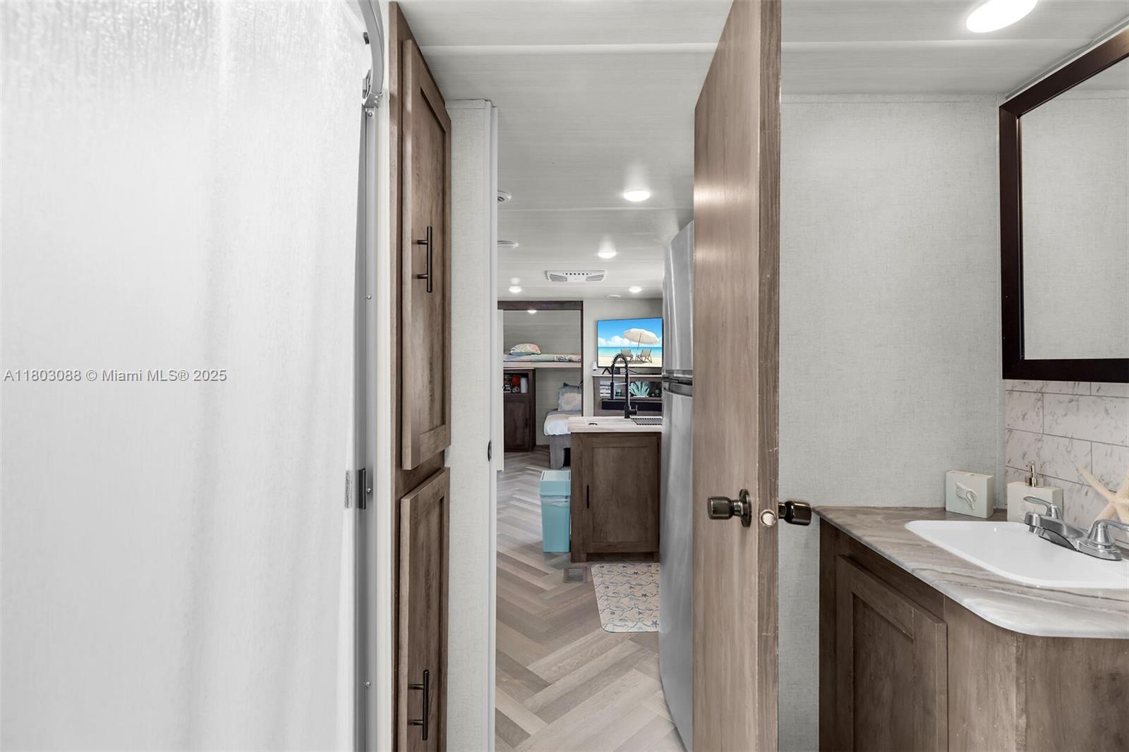 325 Calusa Street Key Largo, FL 33037 - Photo 27 of 34 a bathroom with a sink and a mirror