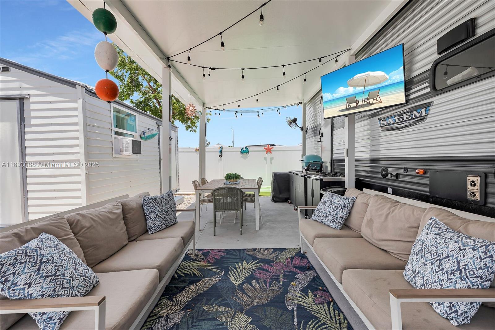 325 Calusa Street Key Largo, FL 33037 - Photo 5 of 34 a living room with furniture a fireplace and a flat screen tv