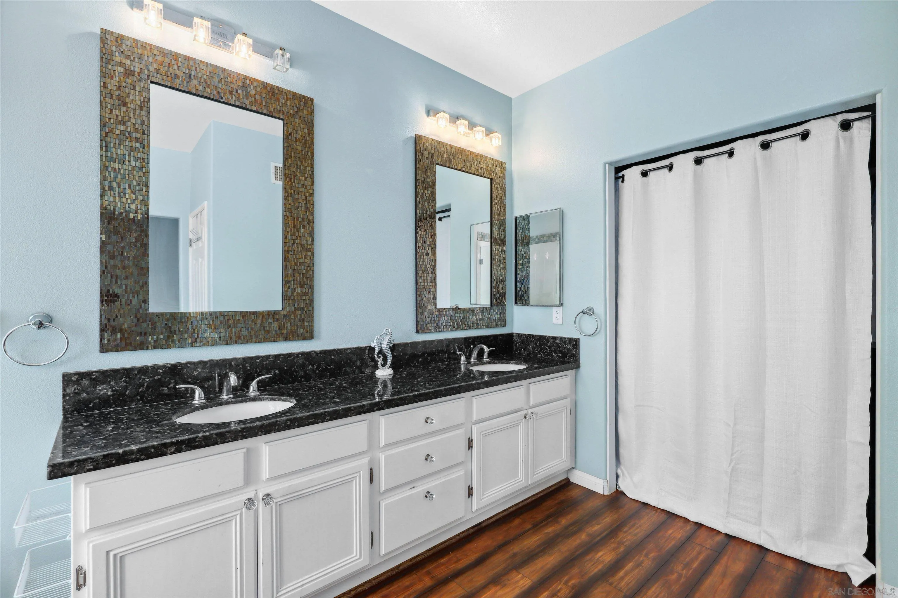 535 Venetia Way Oceanside, CA 92057 - Photo 11 of 27 a bathroom with double sink and a mirror
