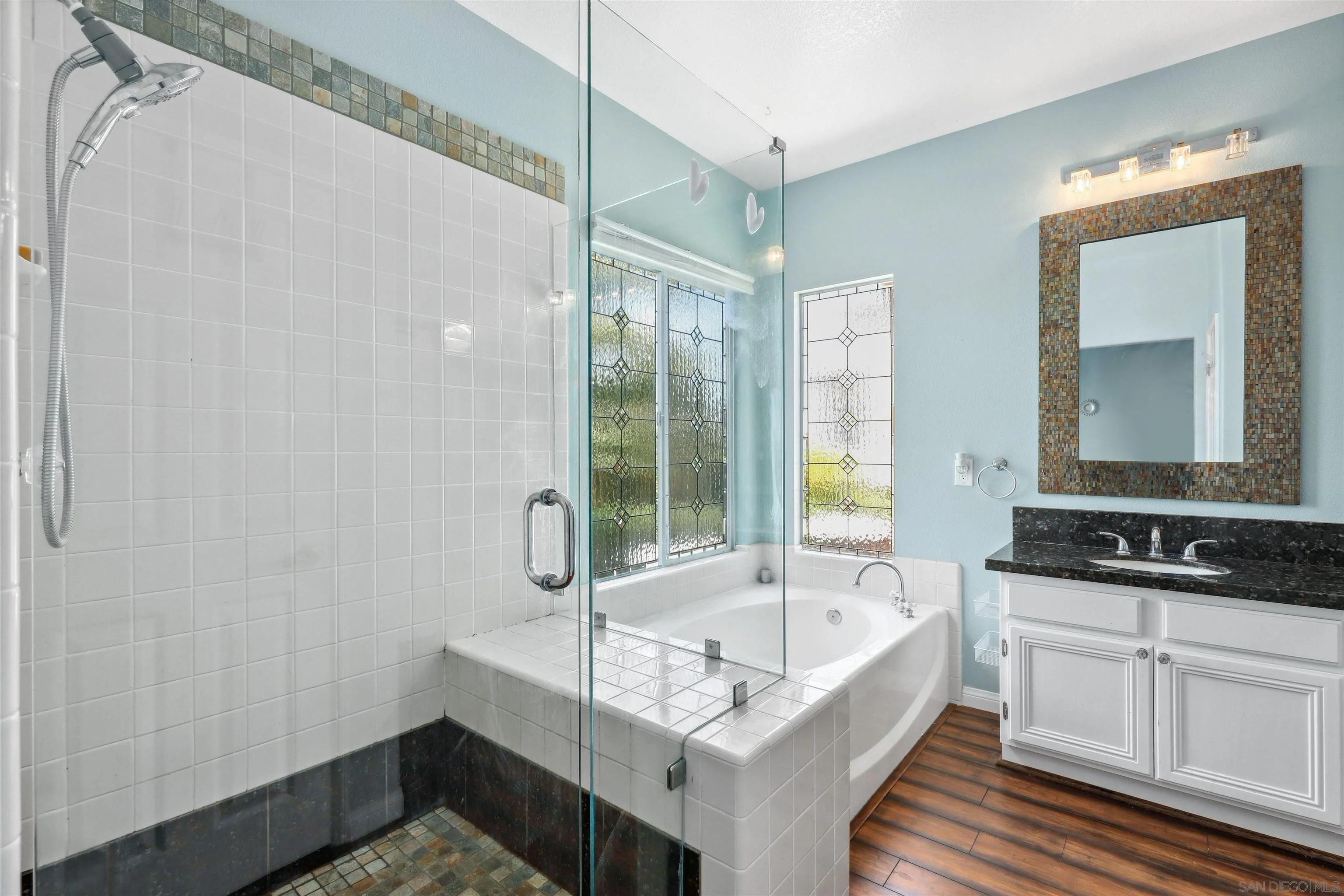 535 Venetia Way Oceanside, CA 92057 - Photo 12 of 27 a bathroom with a tub sink and mirror