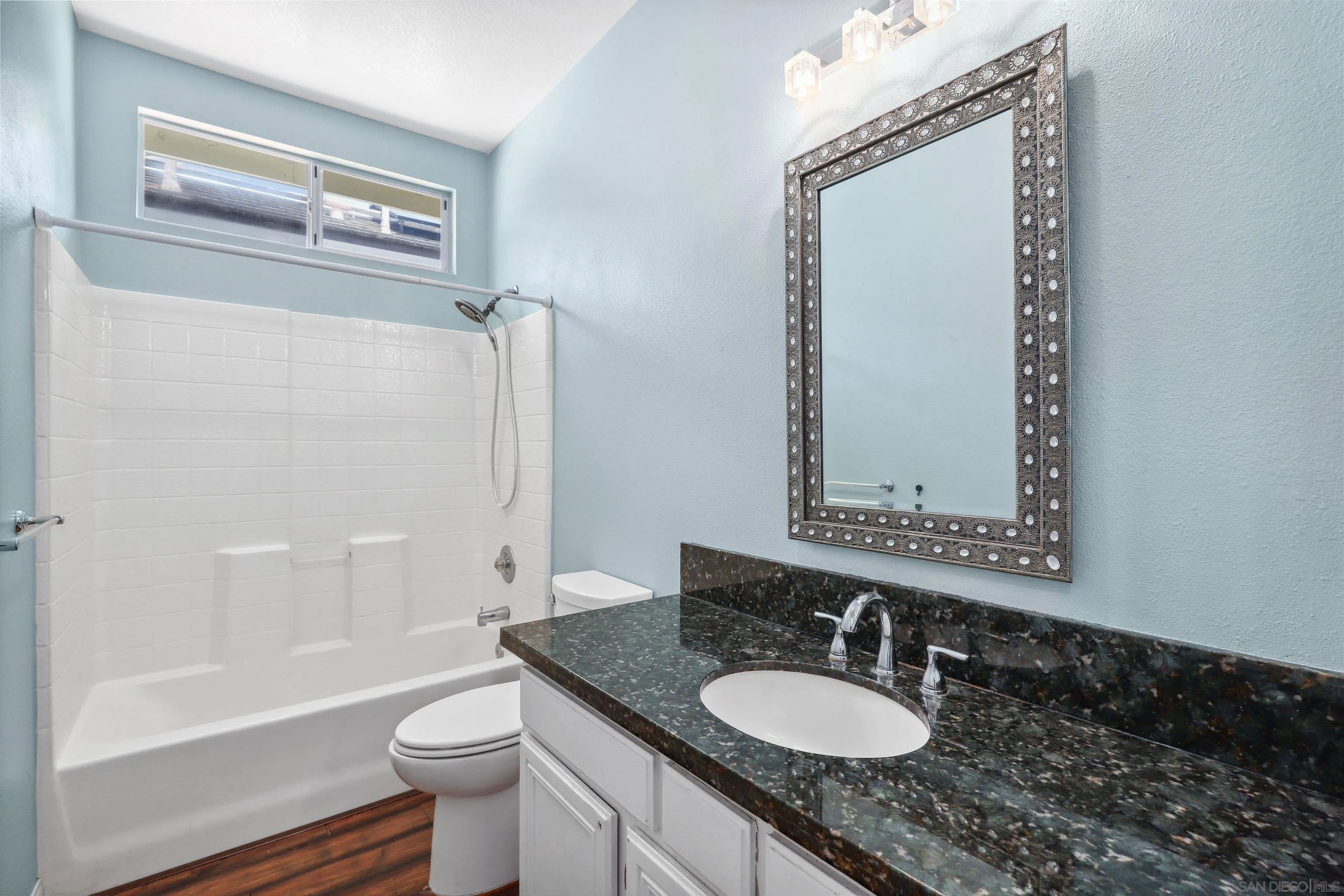 535 Venetia Way Oceanside, CA 92057 - Photo 15 of 27 a bathroom with a granite countertop sink toilet a mirror and bathtub