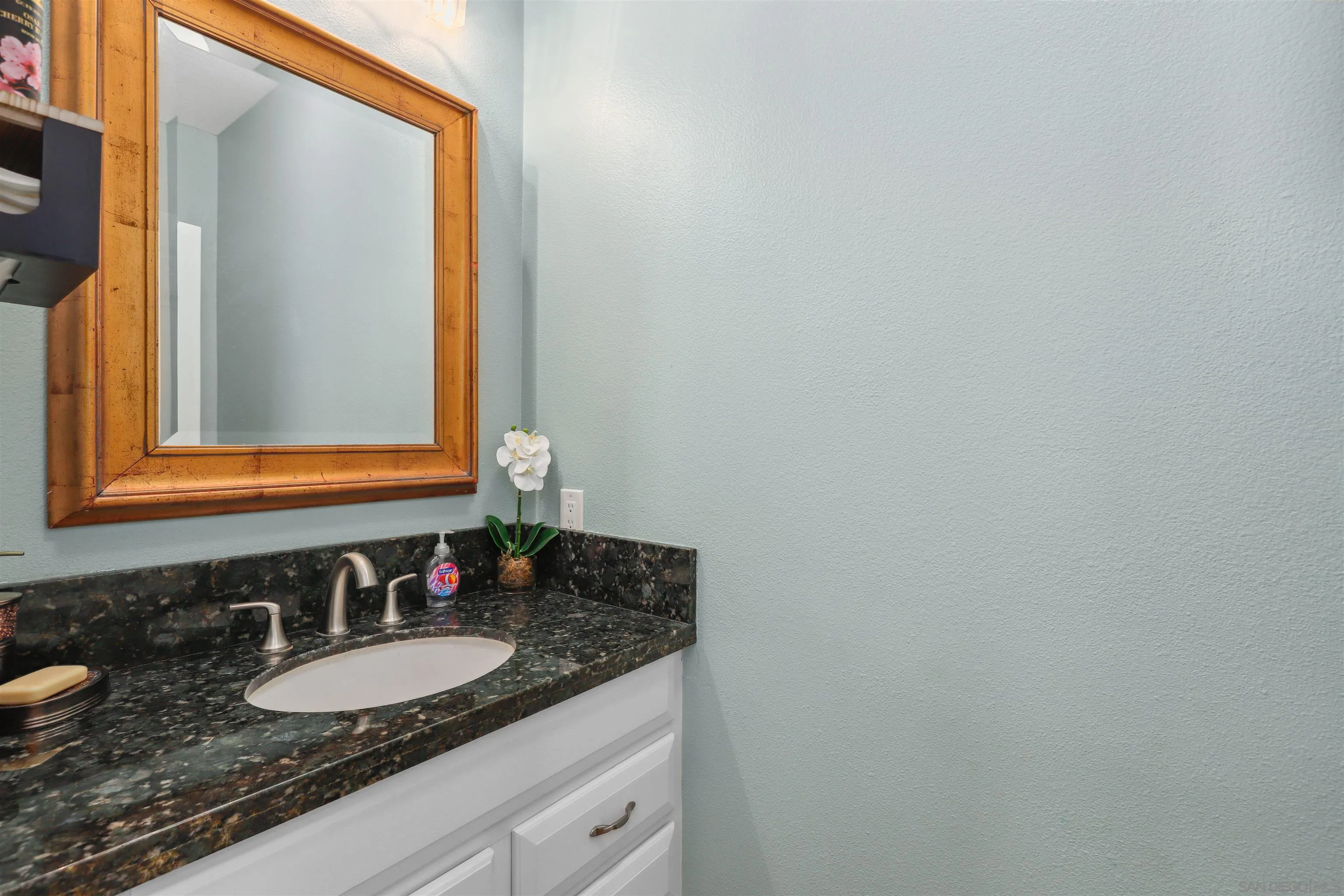 535 Venetia Way Oceanside, CA 92057 - Photo 9 of 27 a bathroom with a granite countertop sink and a mirror