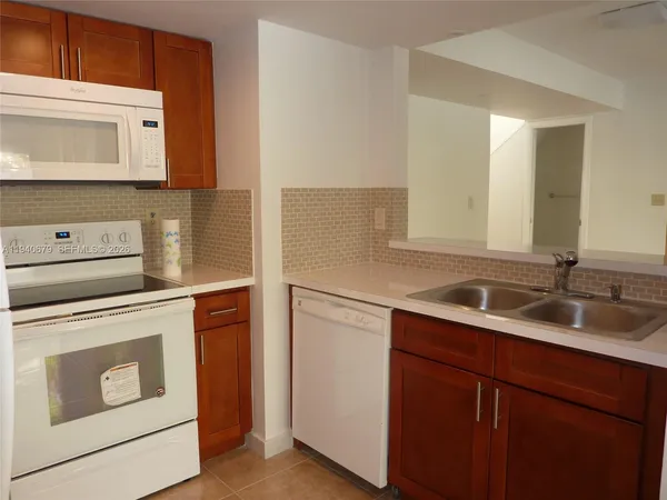 a kitchen with a sink and a stove top oven