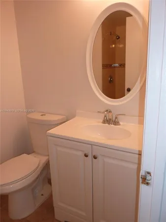 a bathroom with a sink a toilet and mirror