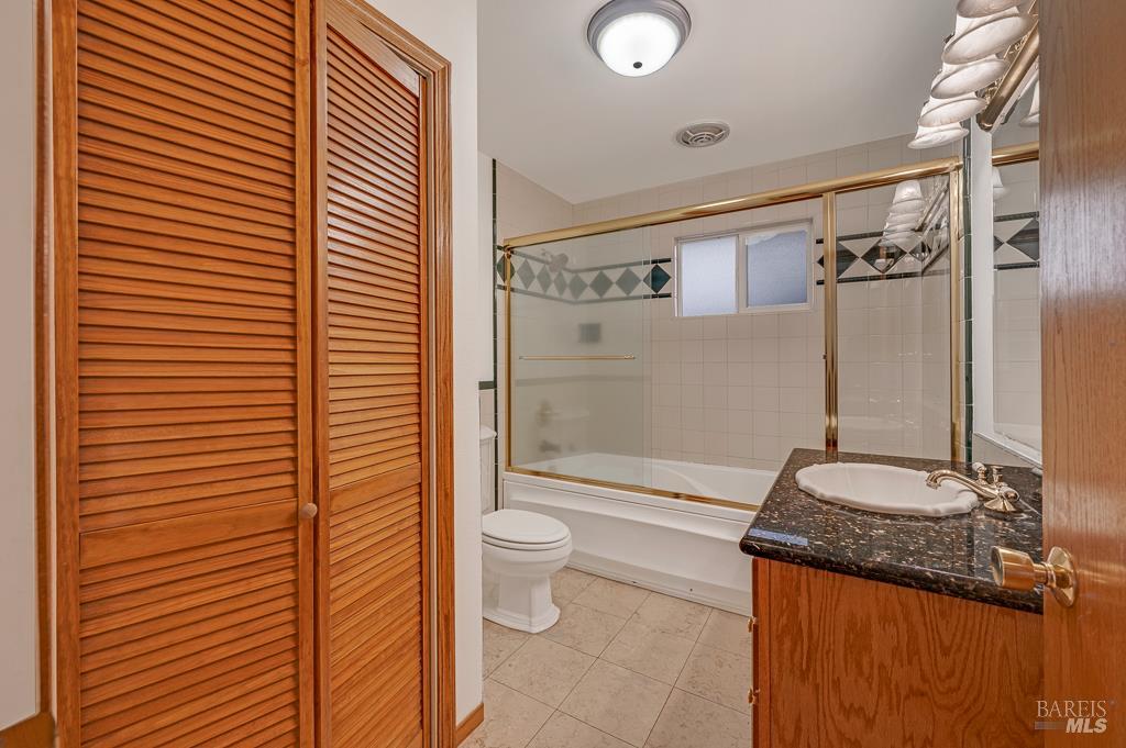 815 Dry Creek Road Healdsburg, CA 95448 - Photo 18 of 37 a bathroom with a granite countertop sink toilet and shower