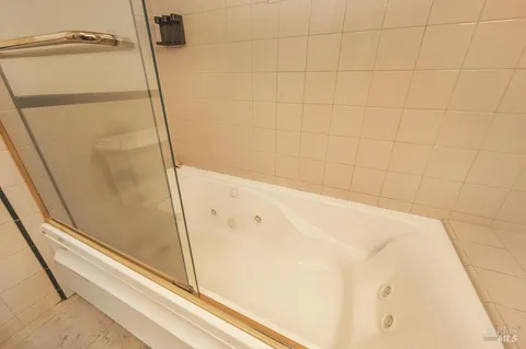 a bathroom with a bathtub and shower