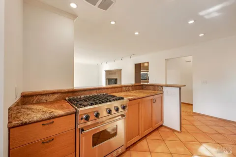 a white stove top oven sitting inside of a kitchen