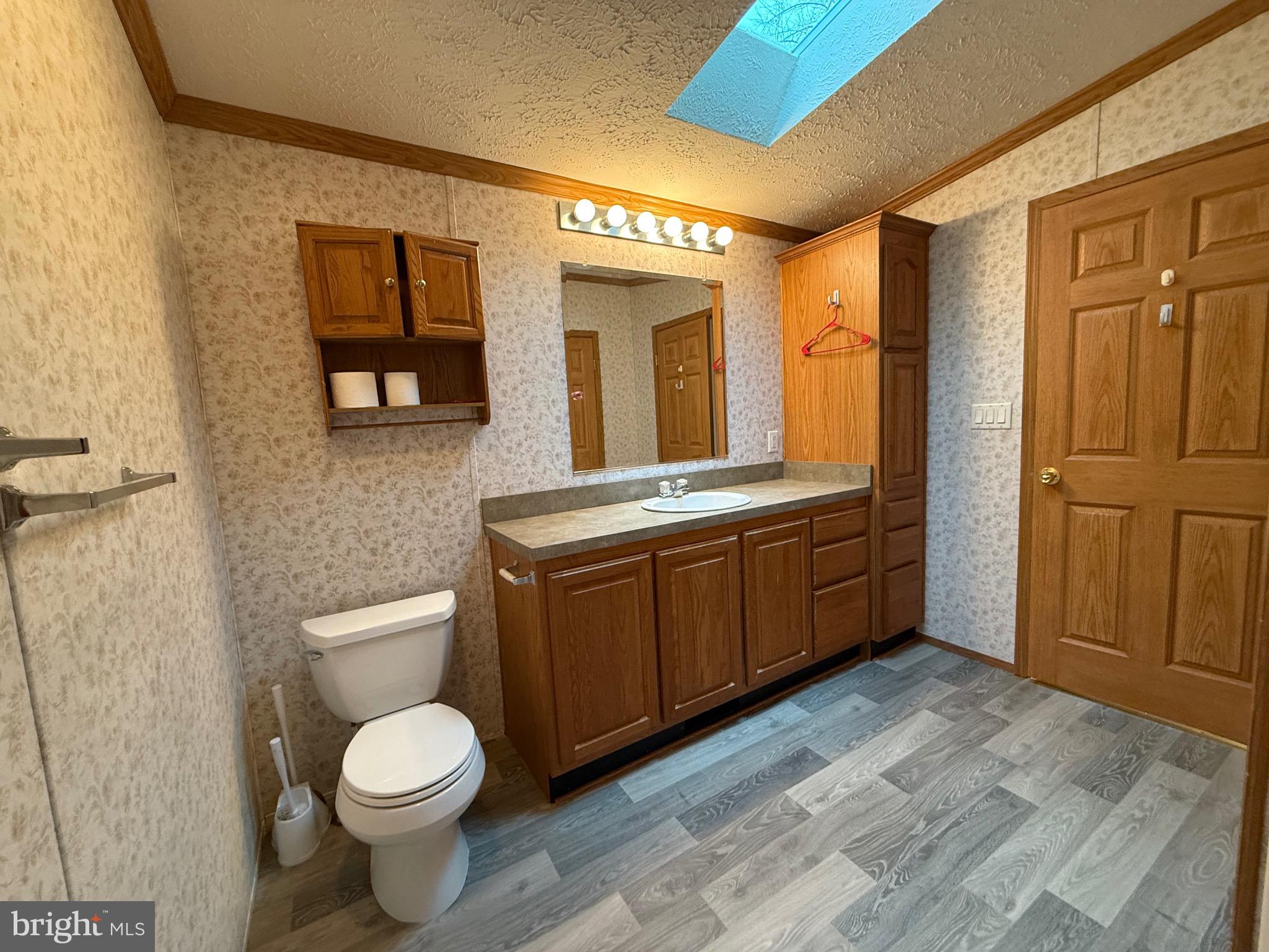 8731 Turkey Ridge Road Breinigsville, PA 18031 - Photo 36 of 68 a bathroom with a toilet sink and mirror