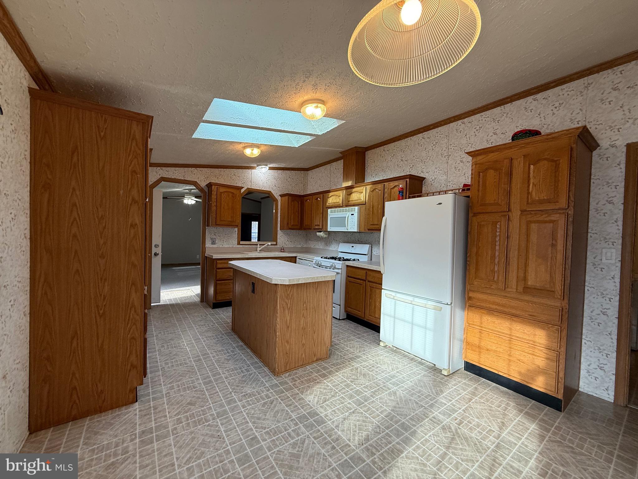 8731 Turkey Ridge Road Breinigsville, PA 18031 - Photo 37 of 68 a kitchen with refrigerator and cabinets