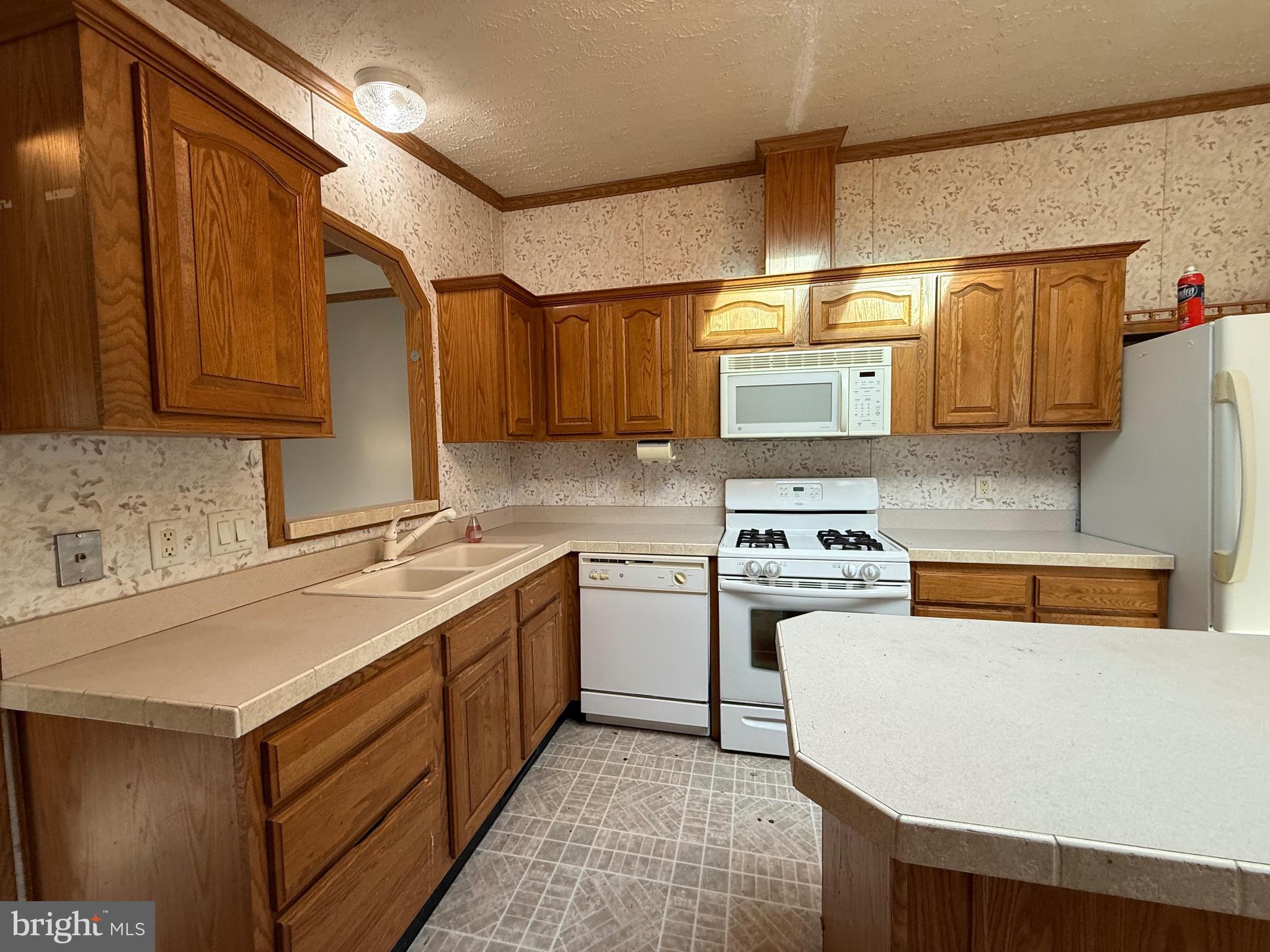 8731 Turkey Ridge Road Breinigsville, PA 18031 - Photo 45 of 68 a kitchen with a stove a sink and a refrigerator