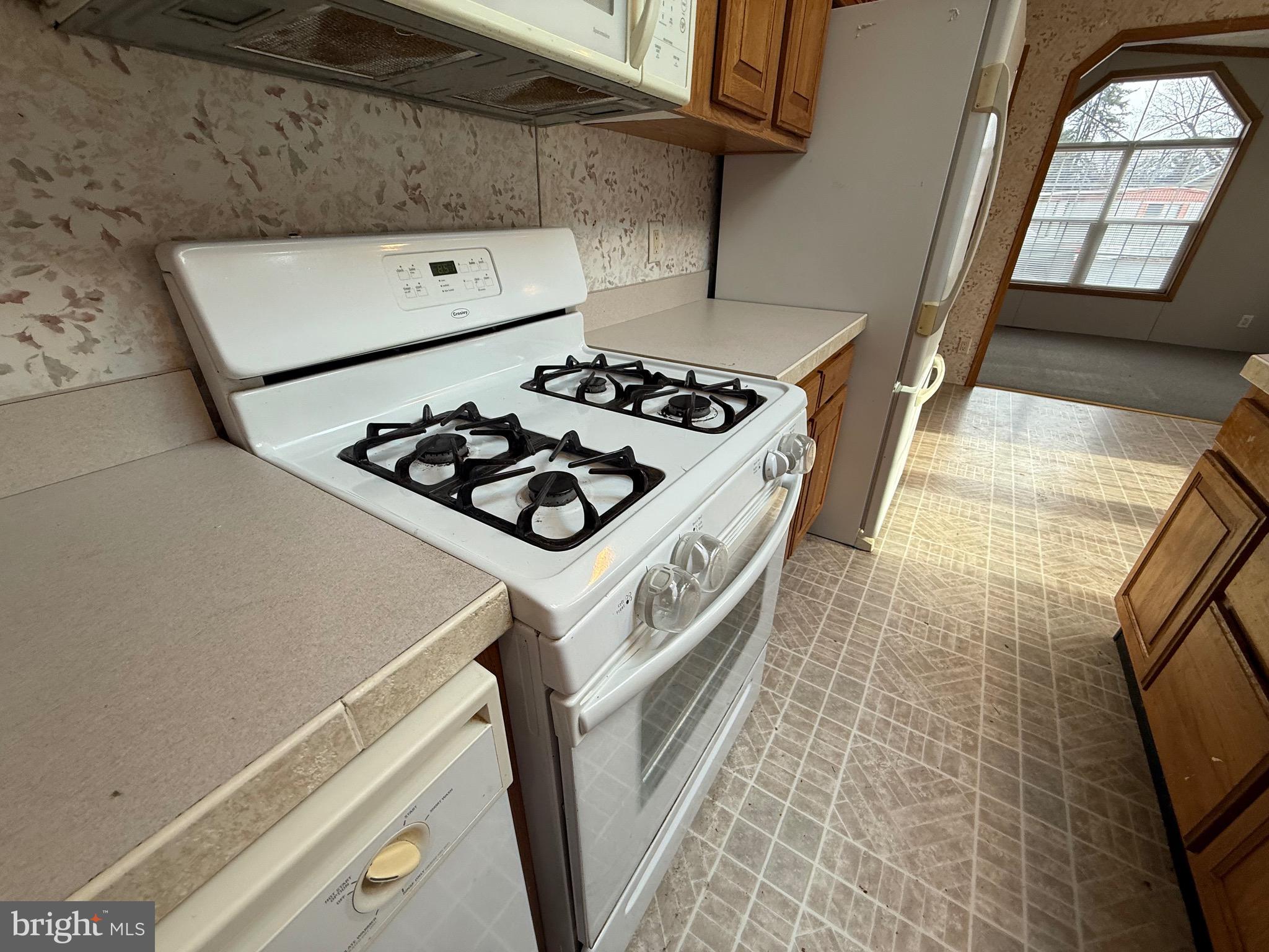 8731 Turkey Ridge Road Breinigsville, PA 18031 - Photo 46 of 68 a kitchen with a stove and a refrigerator