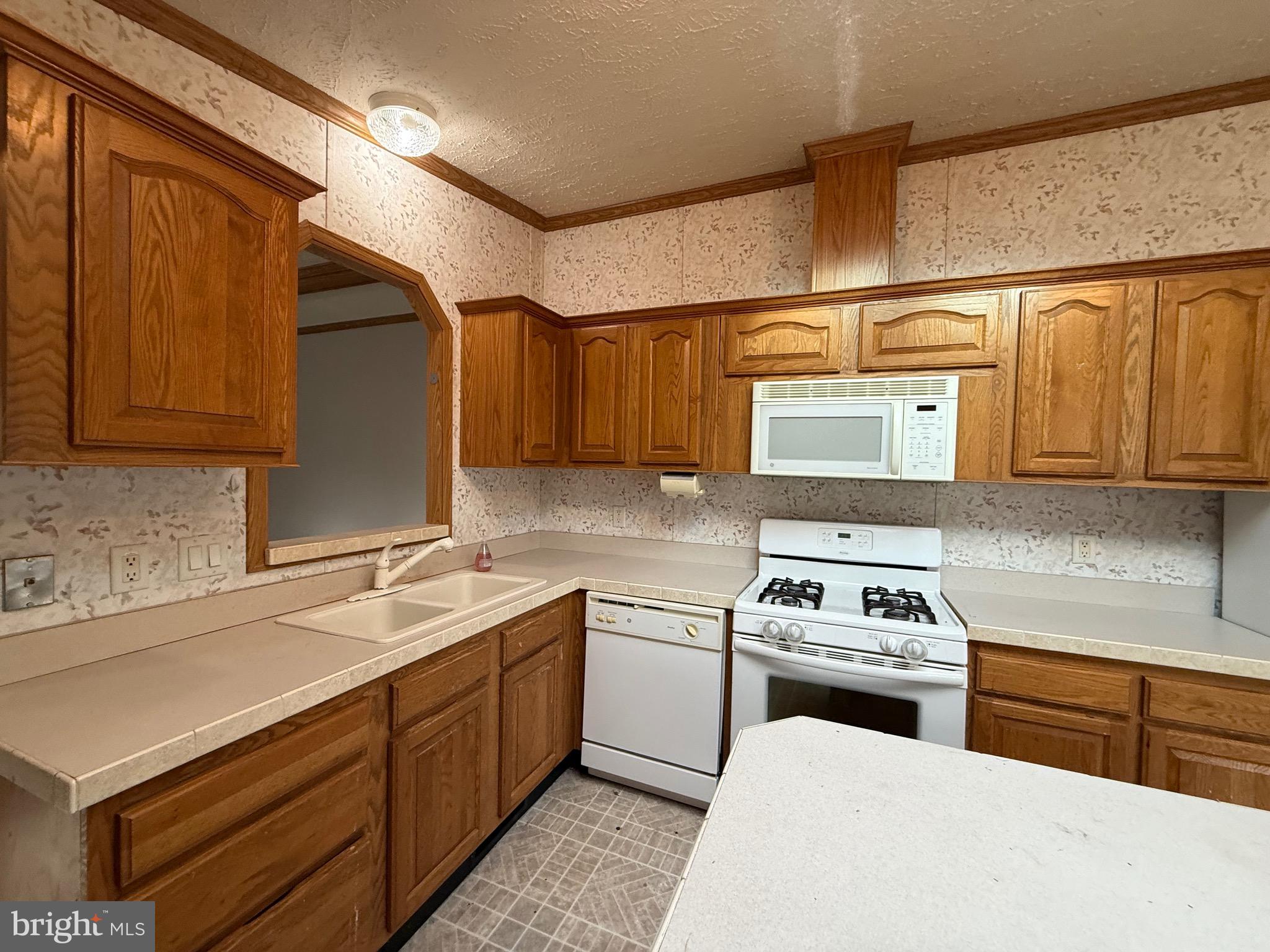 8731 Turkey Ridge Road Breinigsville, PA 18031 - Photo 48 of 68 a kitchen with a sink stove and cabinets