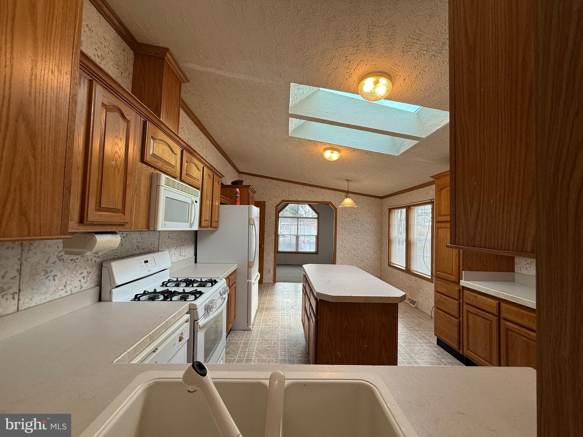 8731 Turkey Ridge Road Breinigsville, PA 18031 - Photo 50 of 68 a kitchen with stainless steel appliances granite countertop a stove a sink dishwasher and a refrigerator with wooden floor