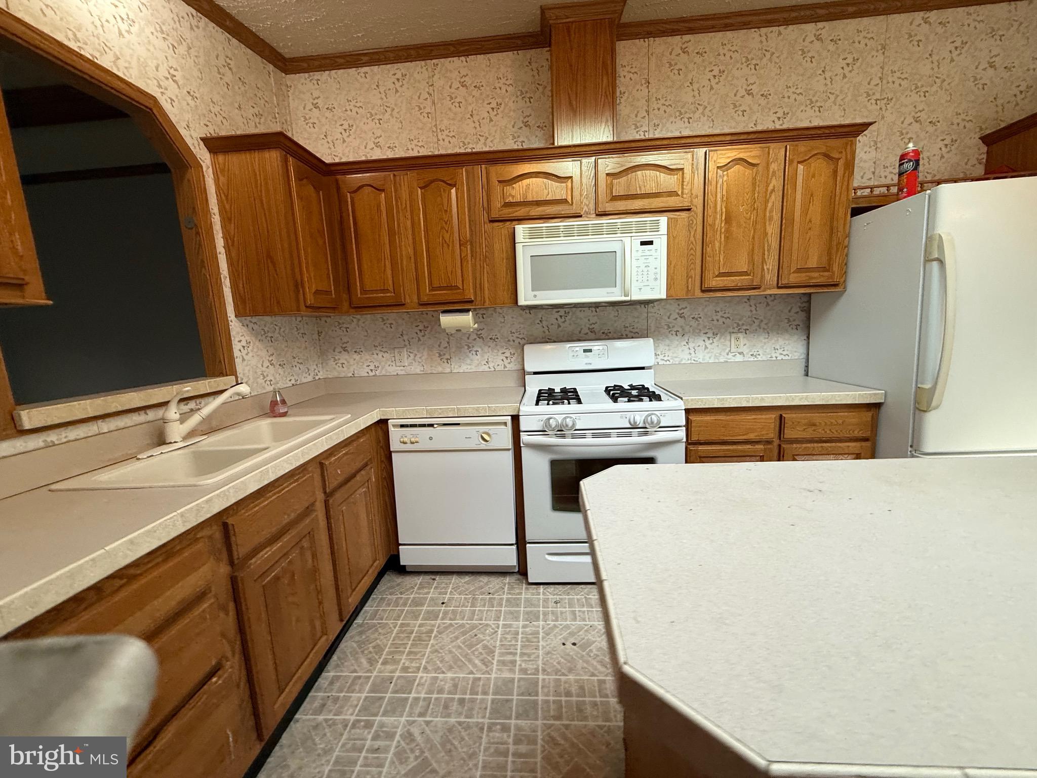 8731 Turkey Ridge Road Breinigsville, PA 18031 - Photo 51 of 68 a kitchen with a sink a stove and a refrigerator