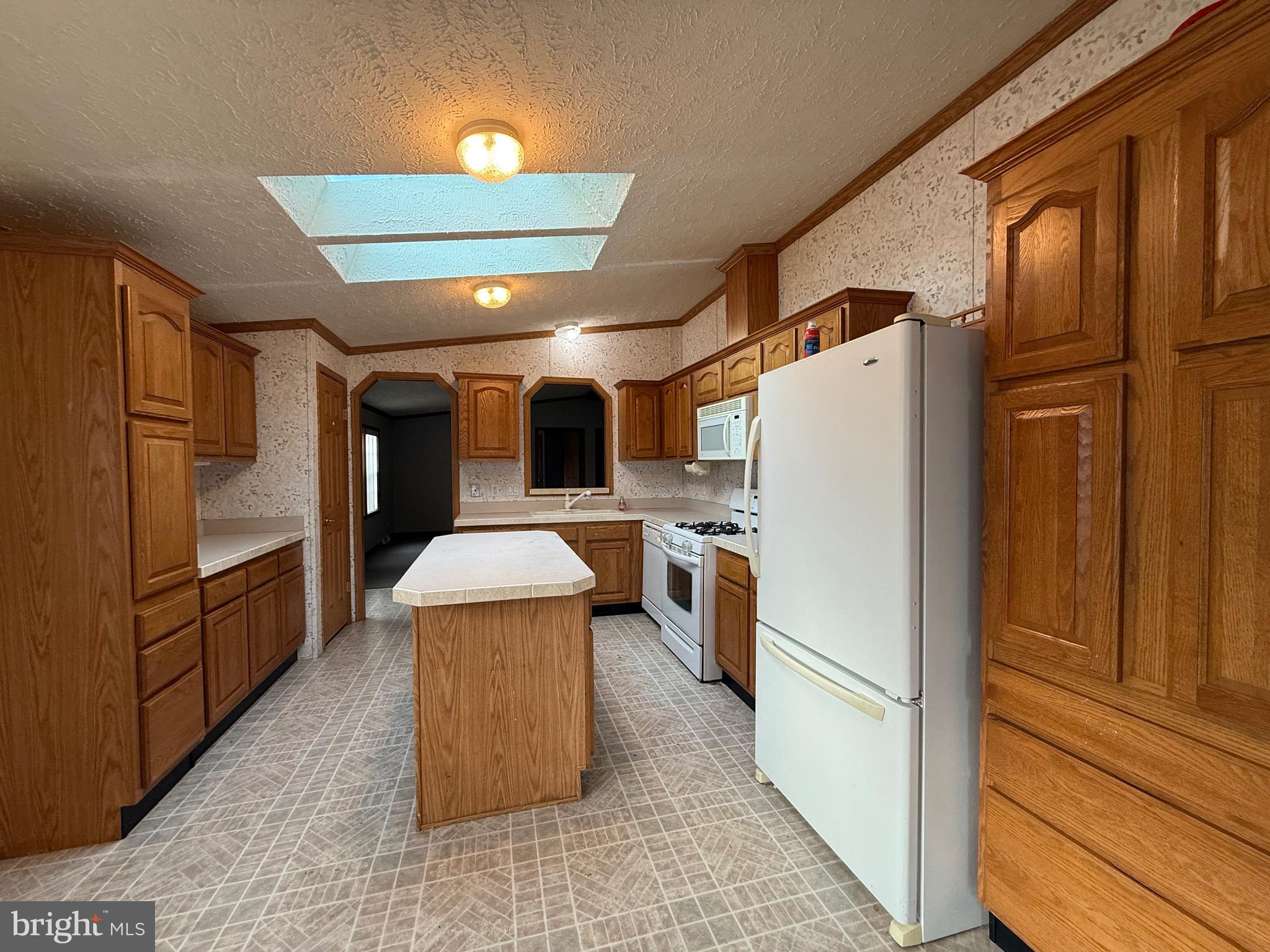 8731 Turkey Ridge Road Breinigsville, PA 18031 - Photo 53 of 68 a large kitchen with stainless steel appliances kitchen island granite countertop a refrigerator and a stove