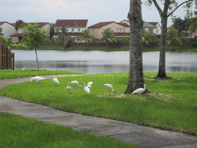 an empty room with wooden floor and a window