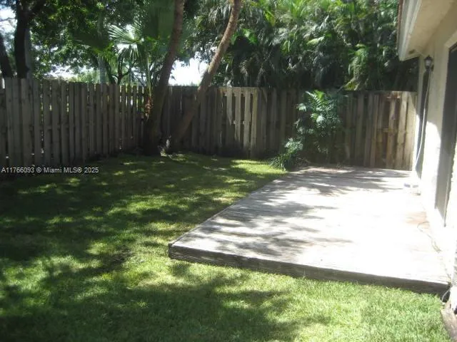 a view of a backyard with tree
