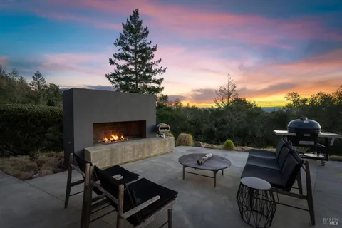 a kitchen with stainless steel appliances granite countertop a table chairs stove and refrigerator