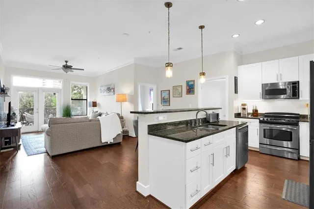 a living room with furniture a flat screen tv and a large window