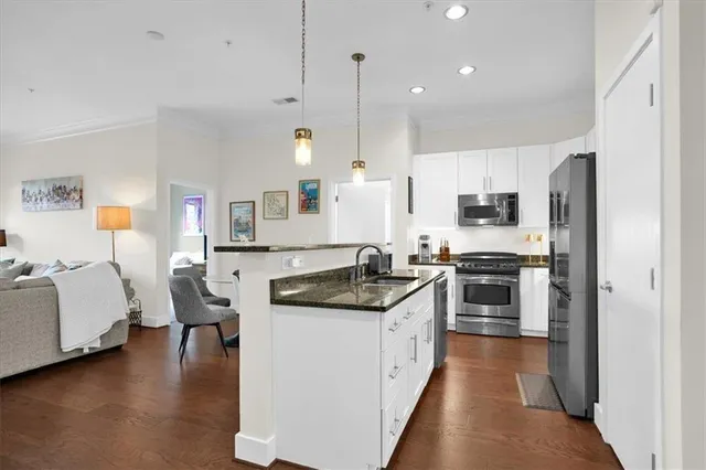 a view of a swimming pool with a lounge chair and trees in the background