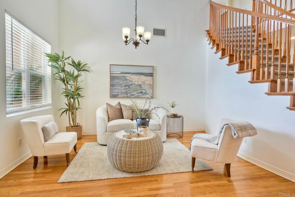 1026 Turnstone Road Carlsbad, CA 92011 - Photo 2 of 38 a living room with furniture and a chandelier