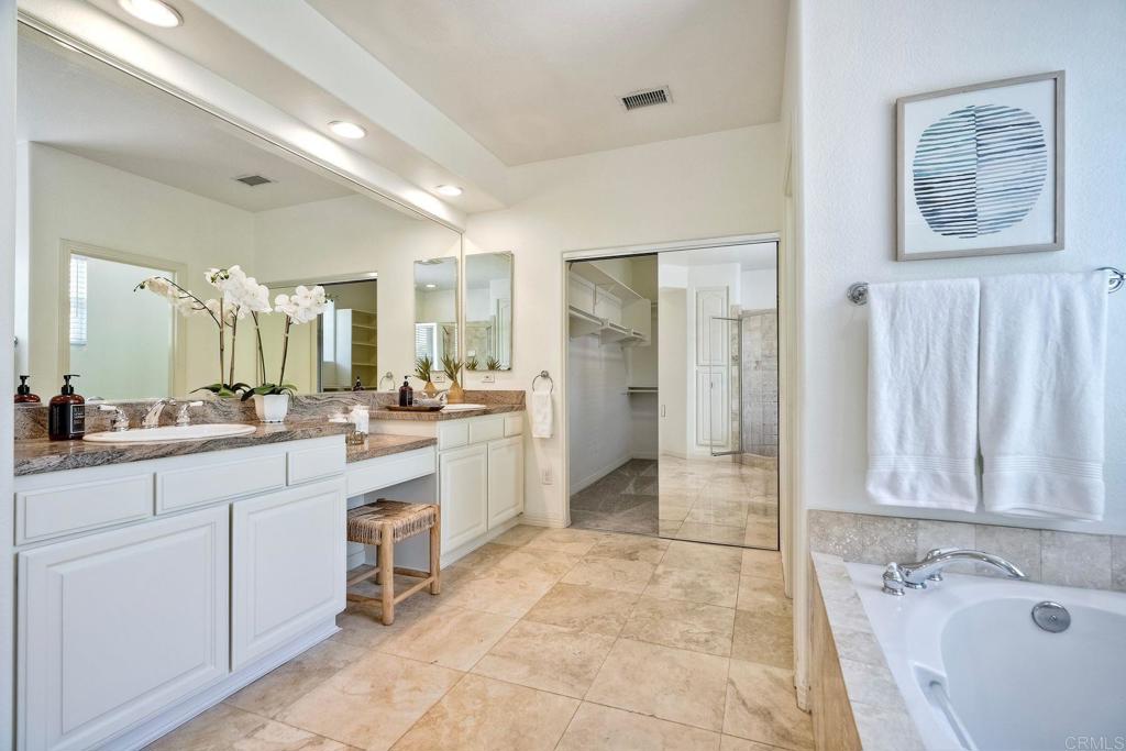 1026 Turnstone Road Carlsbad, CA 92011 - Photo 23 of 38 a large bathroom with a tub sink and mirror