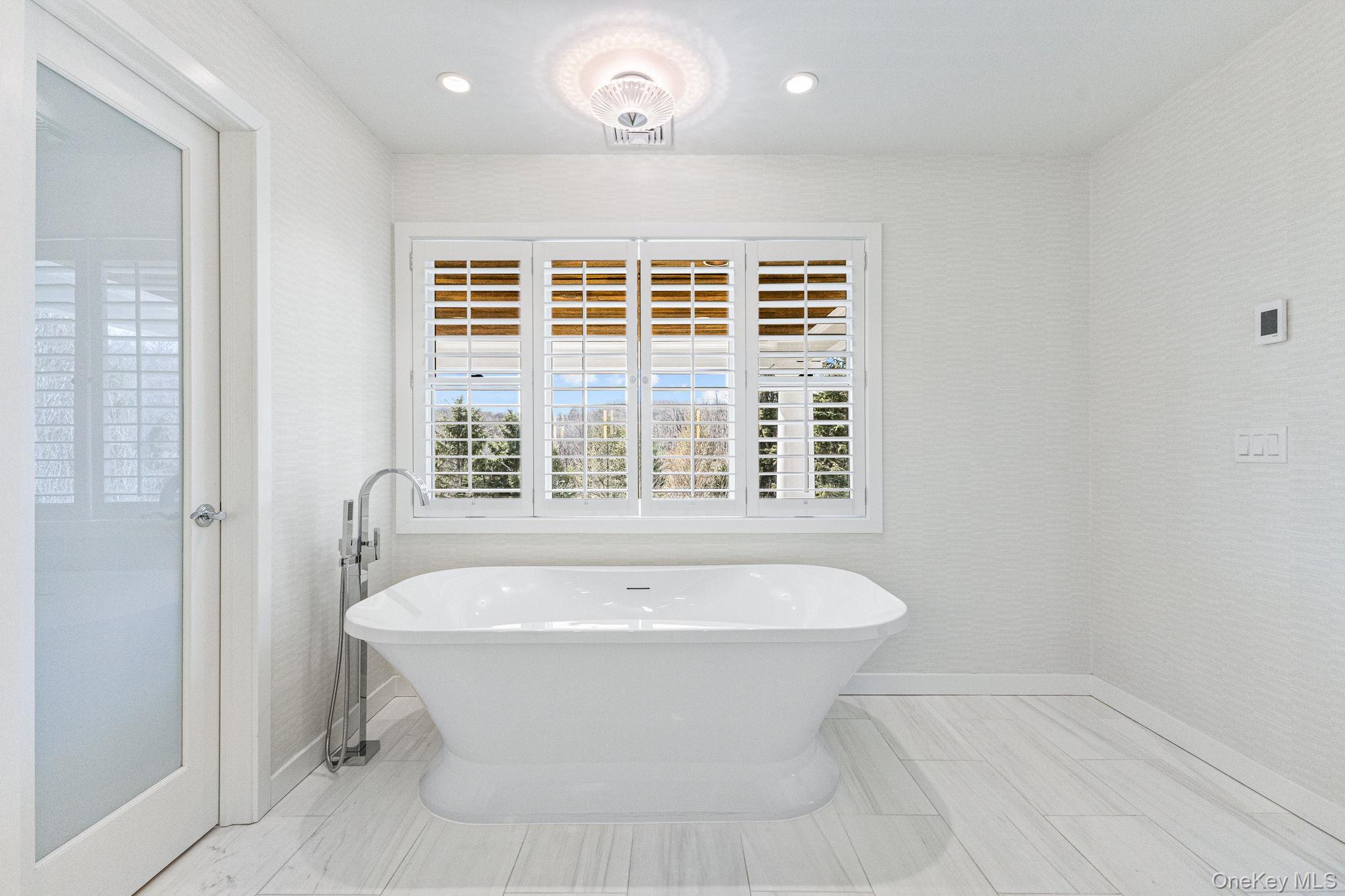 6 Oak Ridge Court West Harrison, NY 10604 - Photo 22 of 45 a bathroom with a bathtub and window