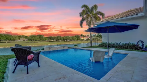 a view of a lake with a table and chairs