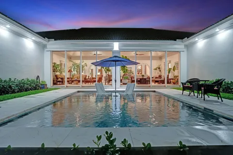 a view of a patio with couches table and chairs and potted plants
