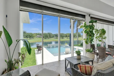 a living room with furniture a rug and a window
