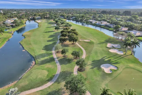 a kitchen with stainless steel appliances granite countertop a lot of cabinets and wooden floor