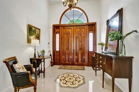 a dining room with furniture a chandelier and window