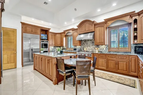 a view of a workspace with furniture and window