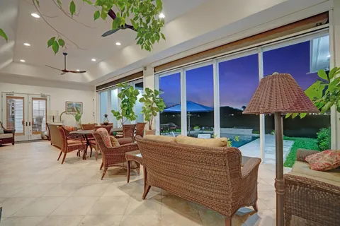 a view of a patio with a table chairs under an umbrella